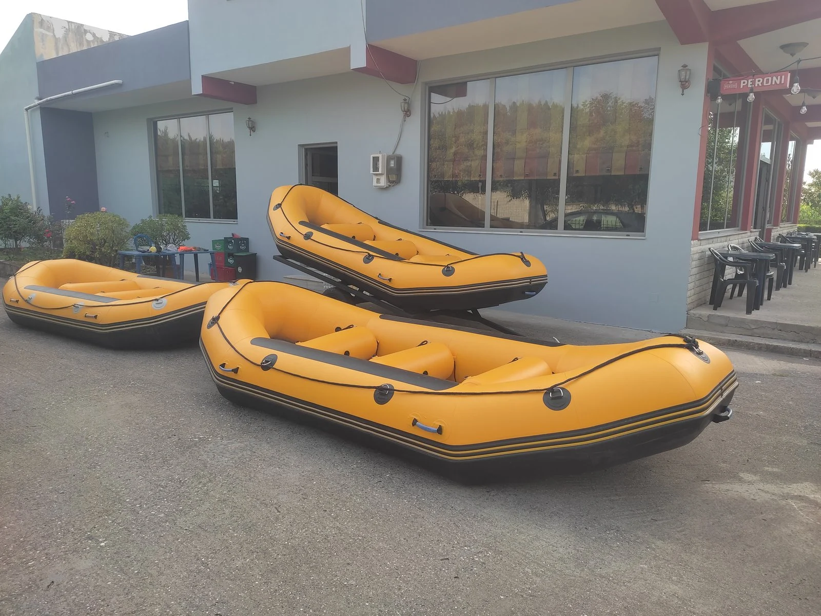 Three yellow rafts in front of the bar-café, ready for a tour