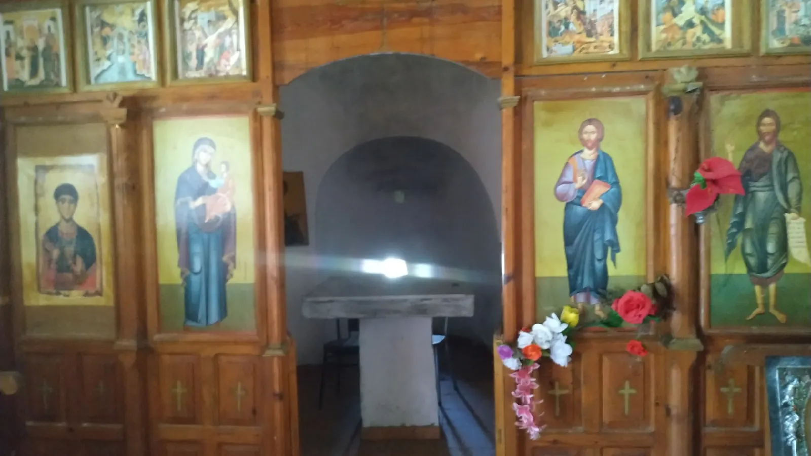 Painted icons of saints on the wooden iconostasis of the Church of Qelova