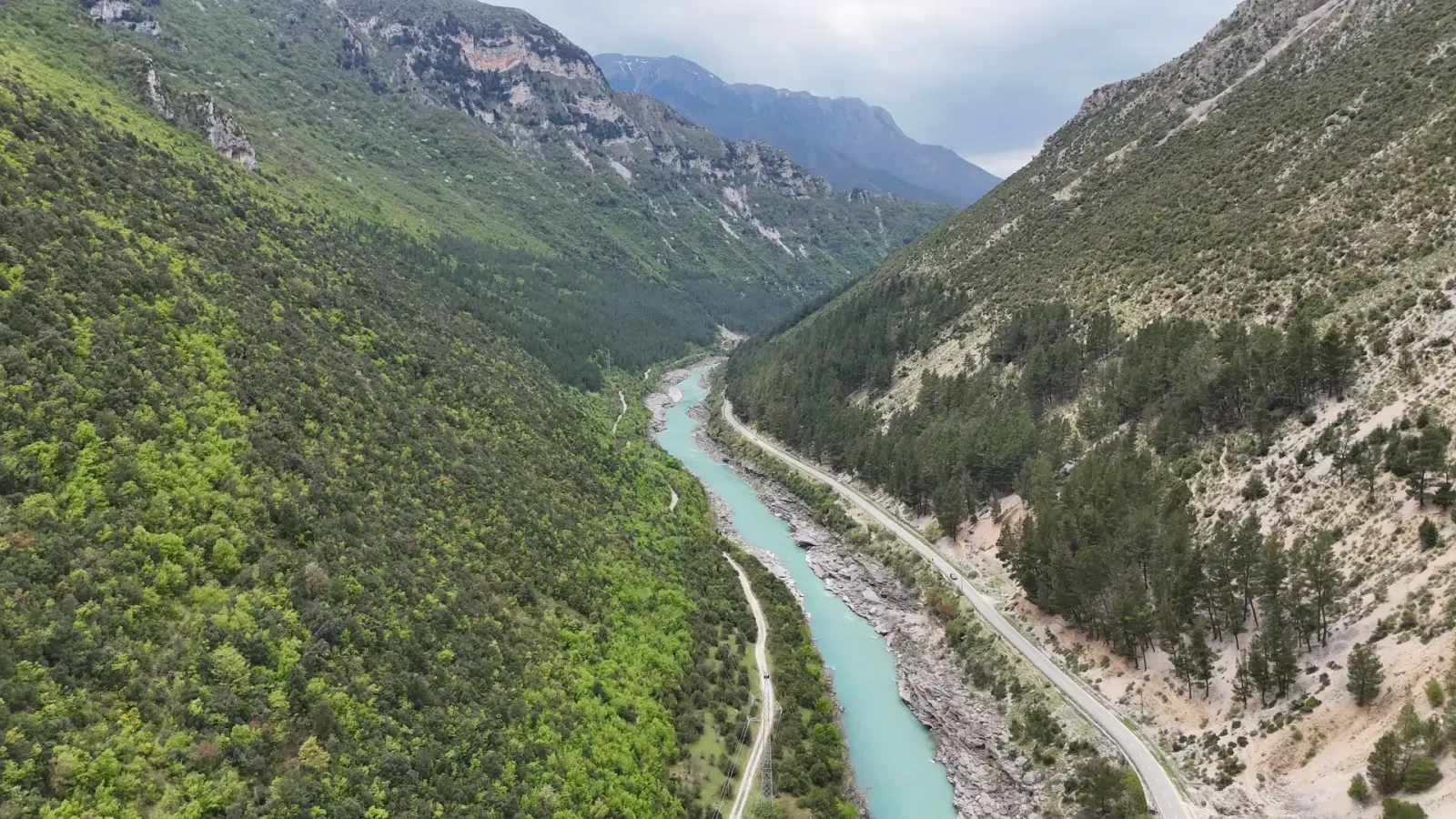 Vjosa river and highway running between forested slopes of the Këlcyrë Gorge