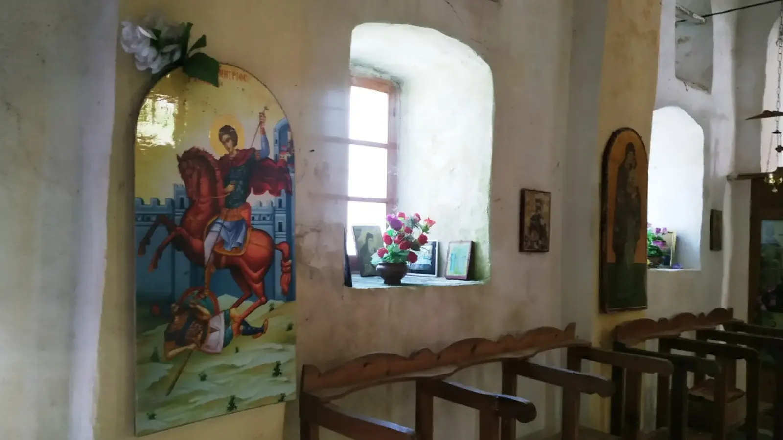 Icon of a mounted saint and deep-set windows inside Saint Mary's Church in Mbrezhdan